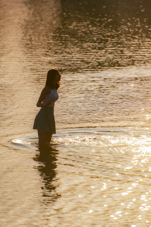 a person standing on the edge of a body of water