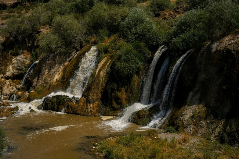 a very tall waterfall is in the middle of some water