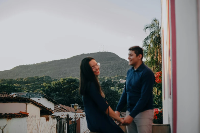 a man and woman standing on top of a roof