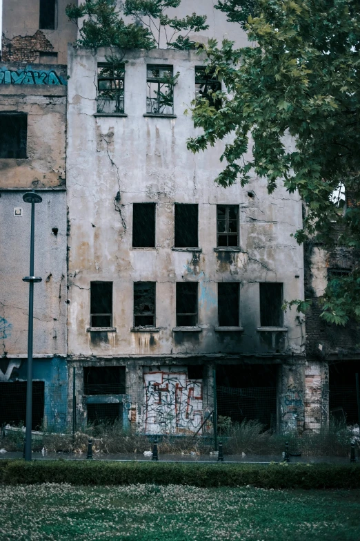 an old building with graffiti written on the side and windows