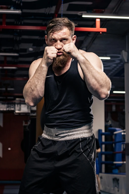 a bearded man with beard and black tank top