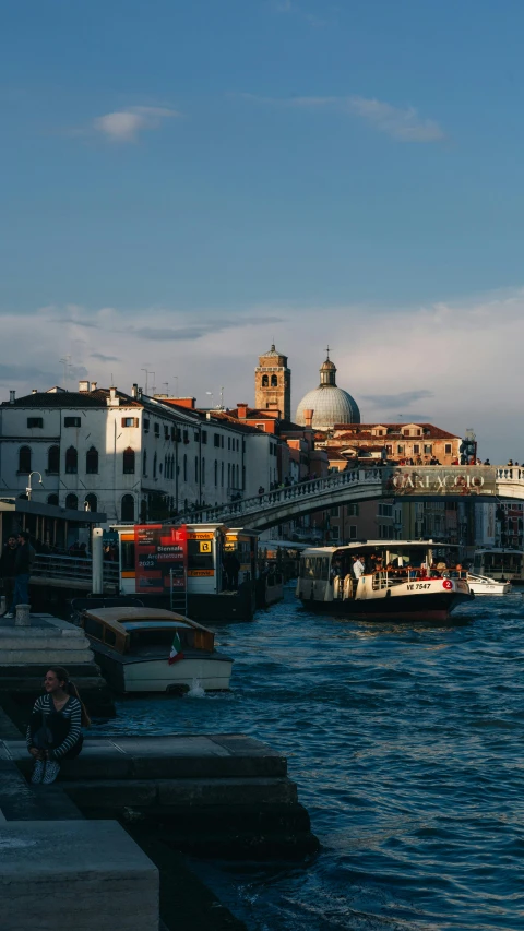 a bridge crossing over water with a couple boats