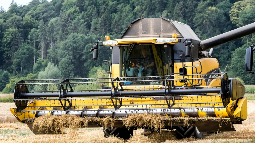 a tractor harvesting hay on a farm in the country