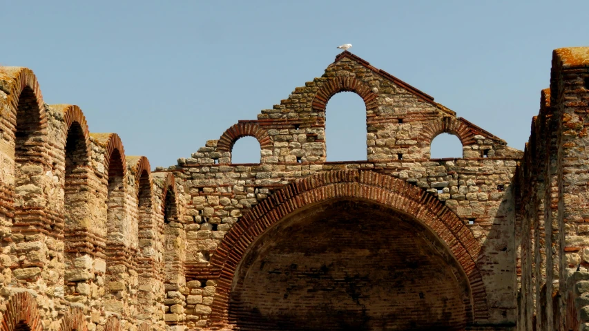 an old brick wall with a clock on it