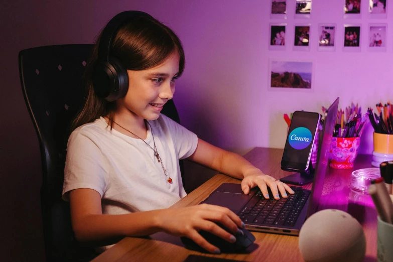 a little girl working on a laptop in the dark