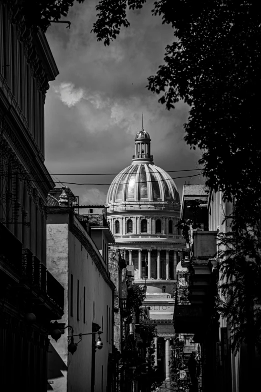 a view of the dome of a church in a dark alley