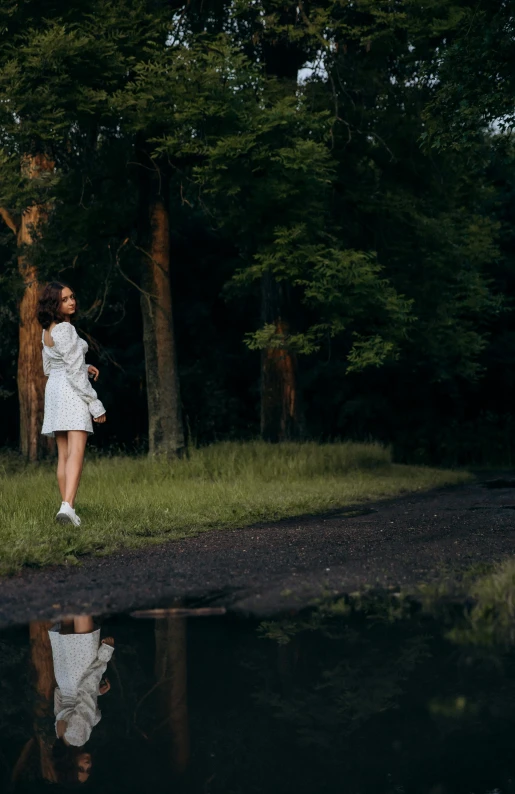 a woman is running in a forest with a reflection