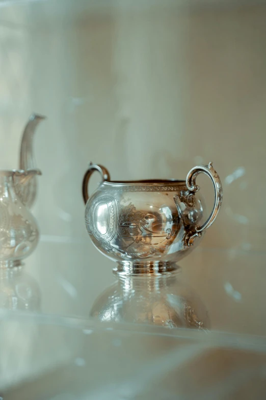 a shiny silver vase sitting on a counter