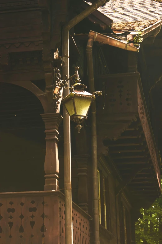 an old looking lamp next to a building