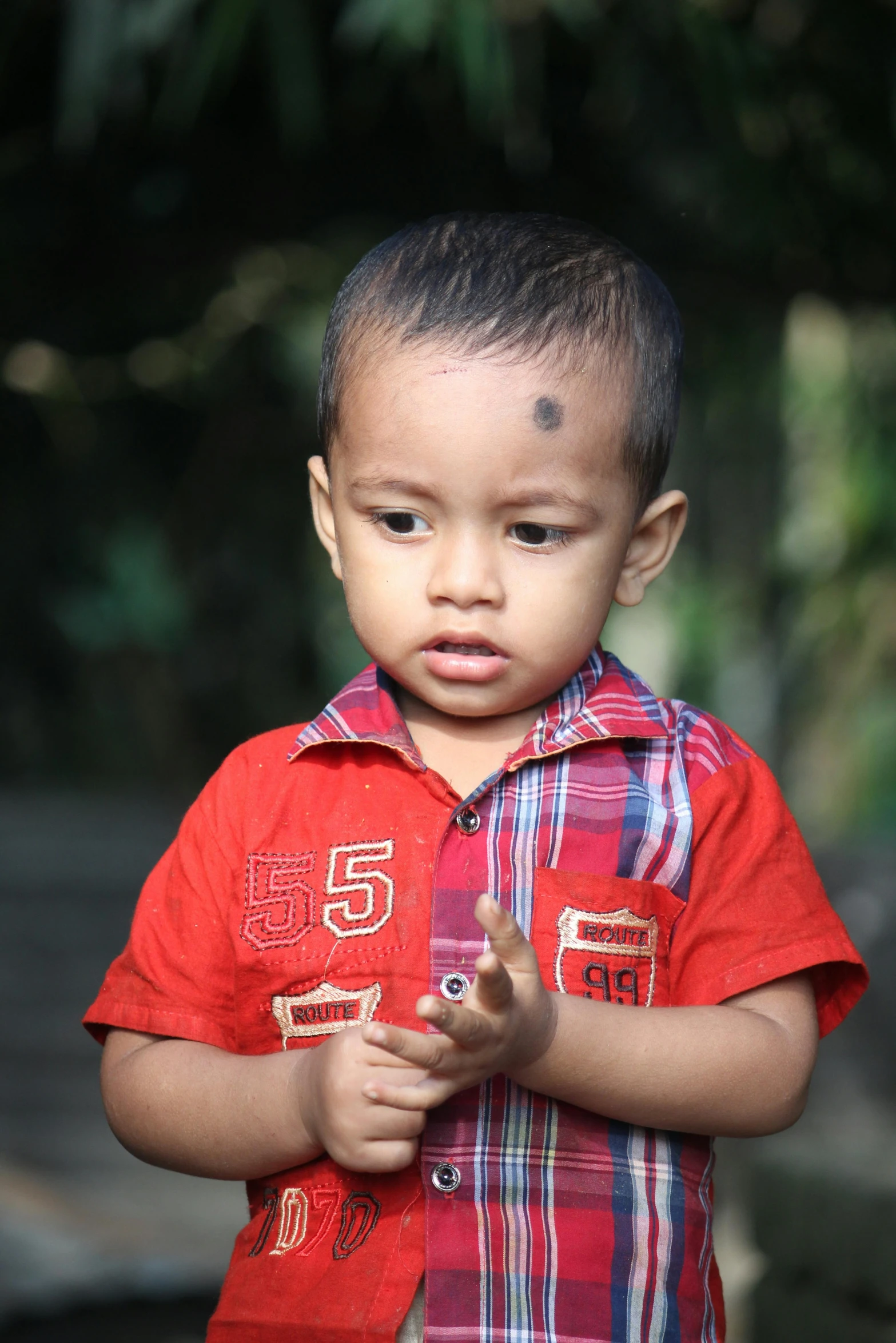 an asian boy is staring with a sad expression