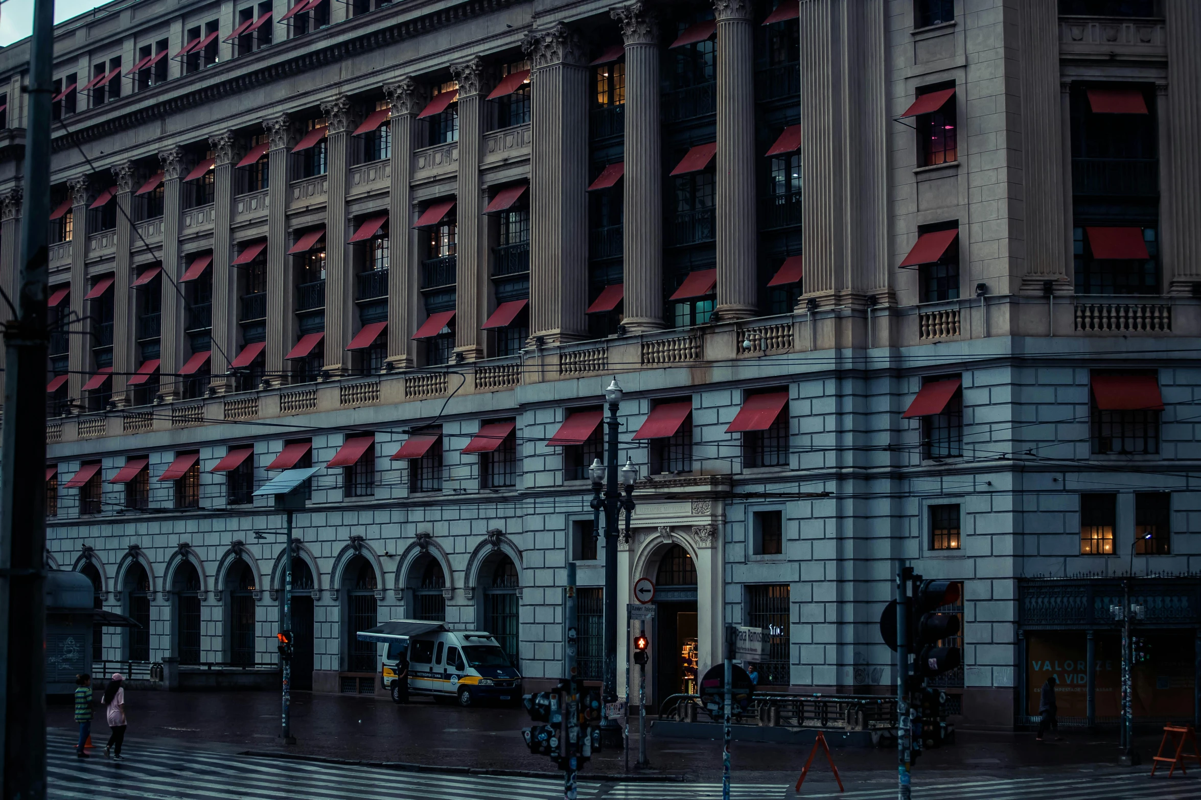 some tall buildings on the street and people