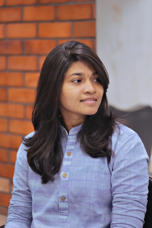 a woman sitting down looking off into the distance