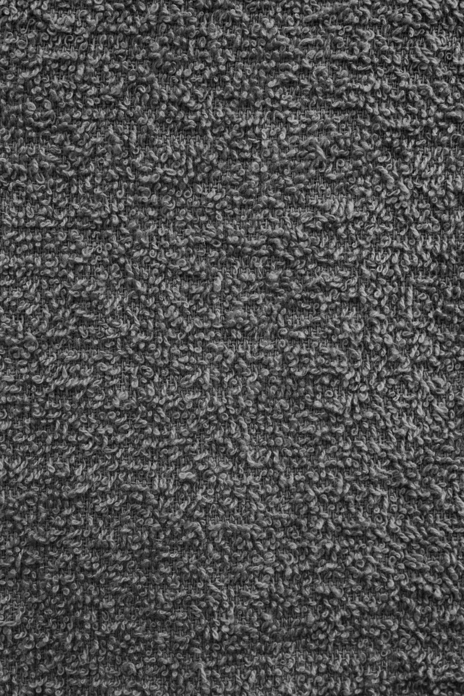 a grey carpet with some black dots