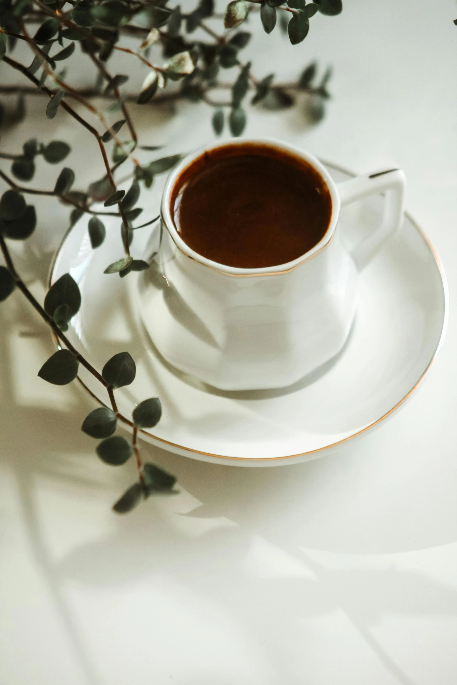 a white coffee cup sitting on top of a saucer