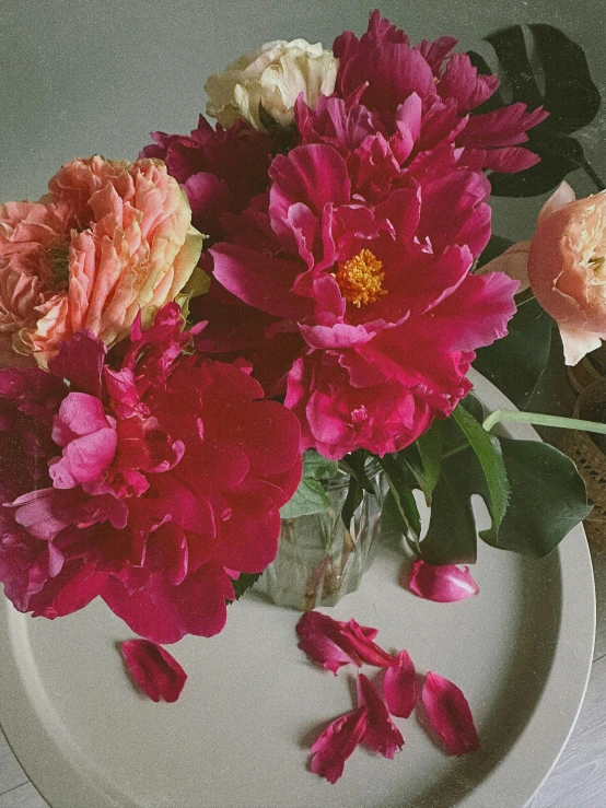 a table with flowers on it and a cup of flowers in the middle