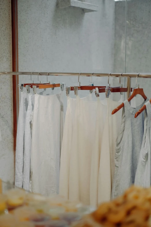 a table topped with pants hanging from clothes racks