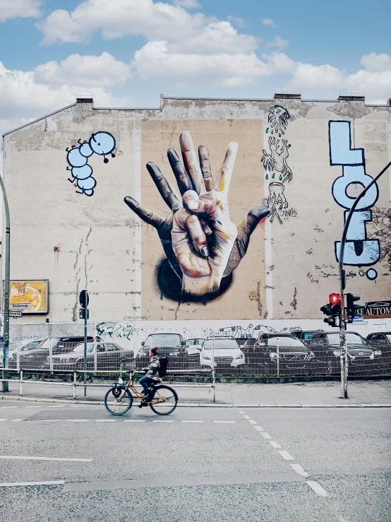 an old building with large hand and feet painted on it