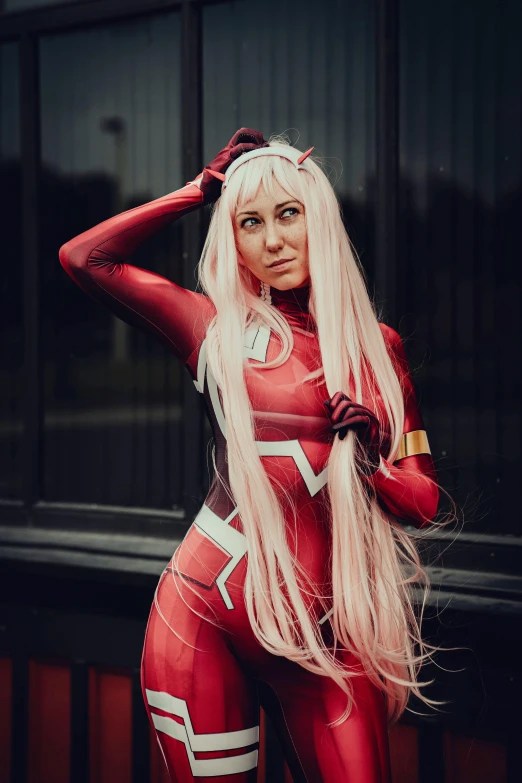 woman in red cosplay outfit posing for camera