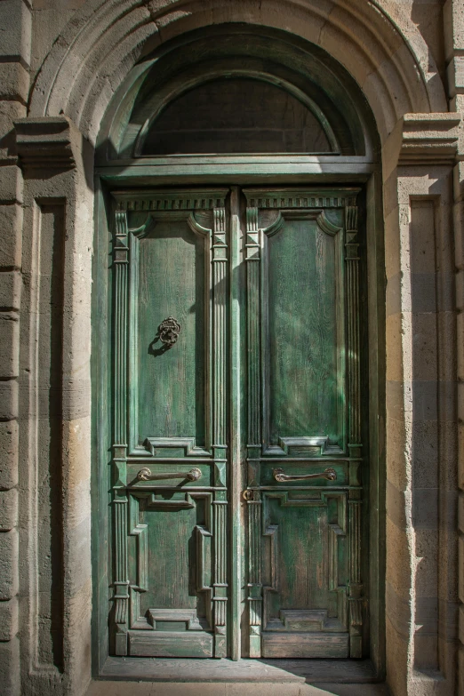 a green door is open at the entrance