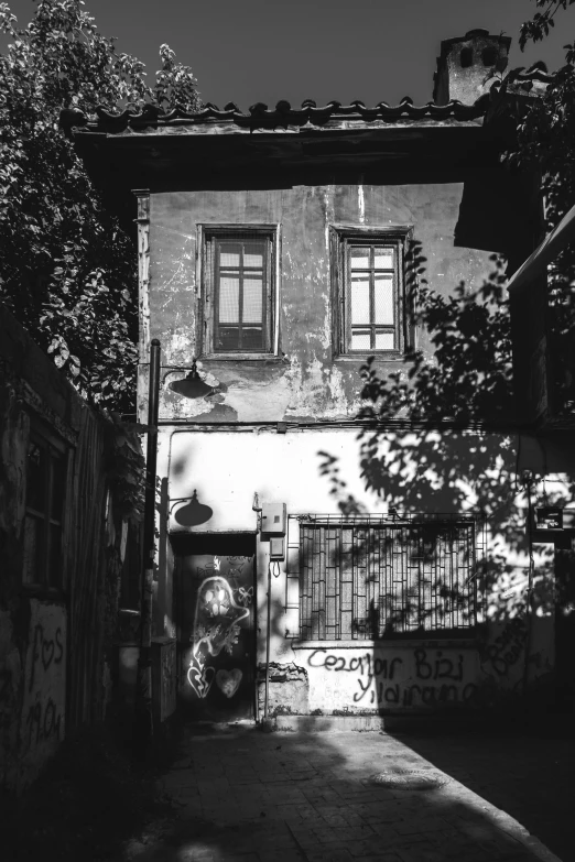 a building that has graffiti on it and is in front of a fence