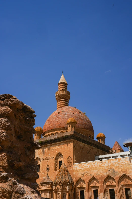 a large building with a domed roof and two towers