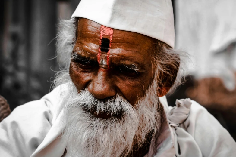 a man with a cross forehead is standing