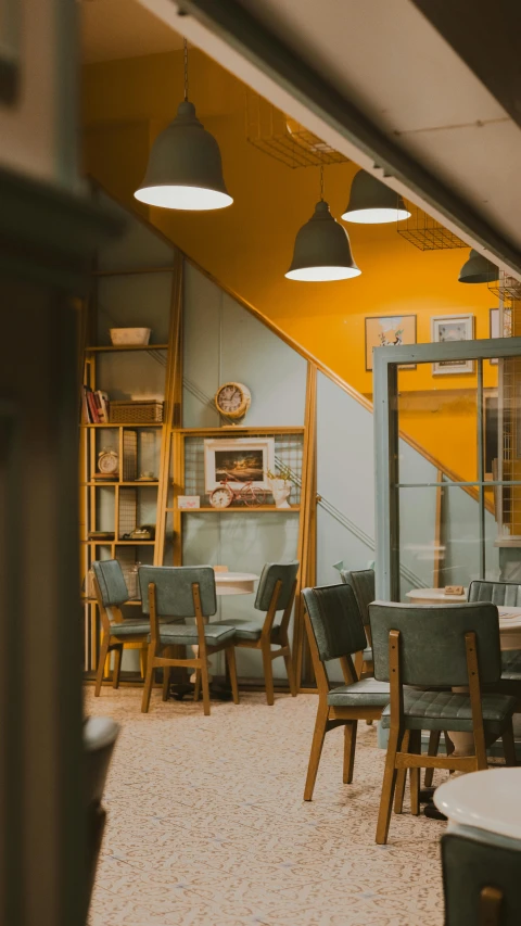 a room filled with wooden tables and grey chairs