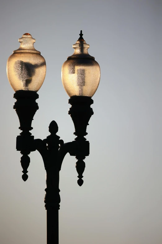 the street light is turned on to have two lights on top of it