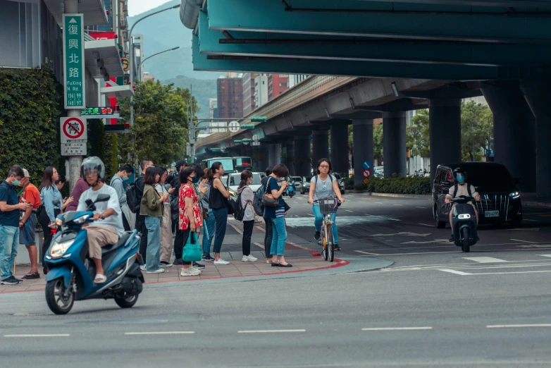 a woman with a large bag riding a motorcycle