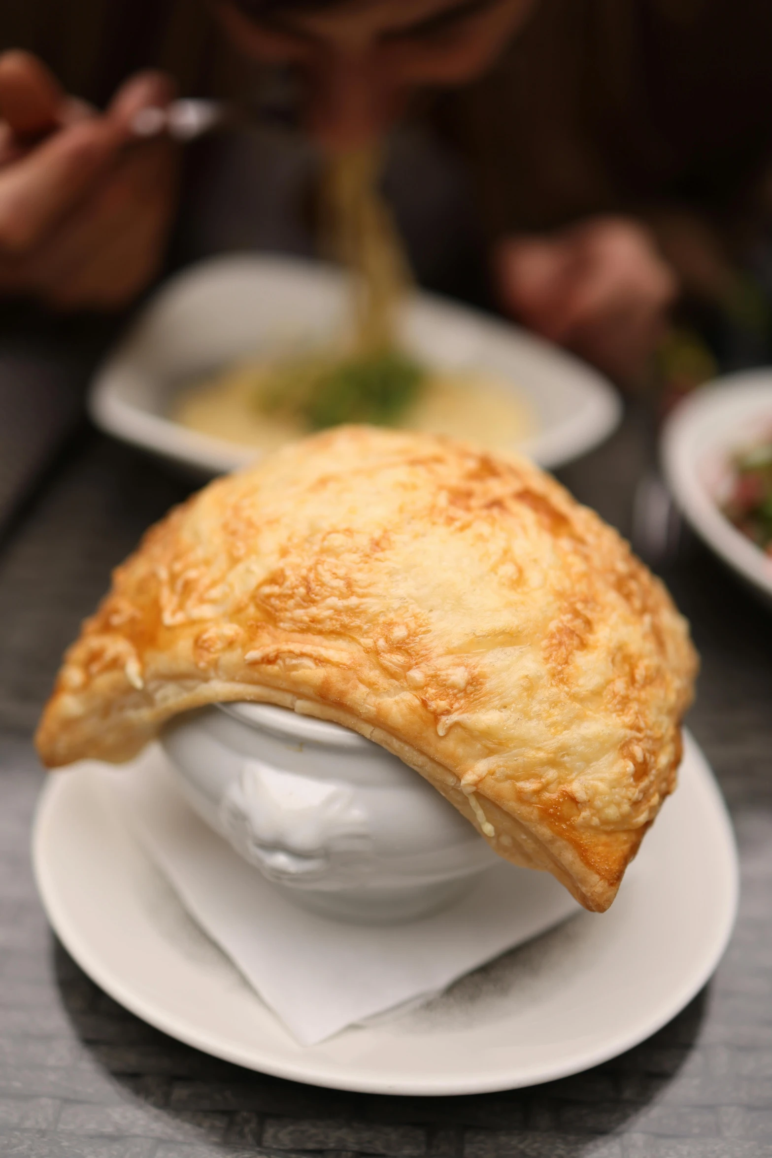 a puff pastry covered in cheese and sprinkled with parsley