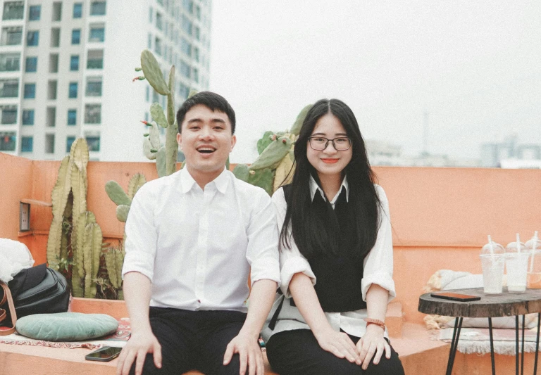 a couple poses on the roof of an apartment building