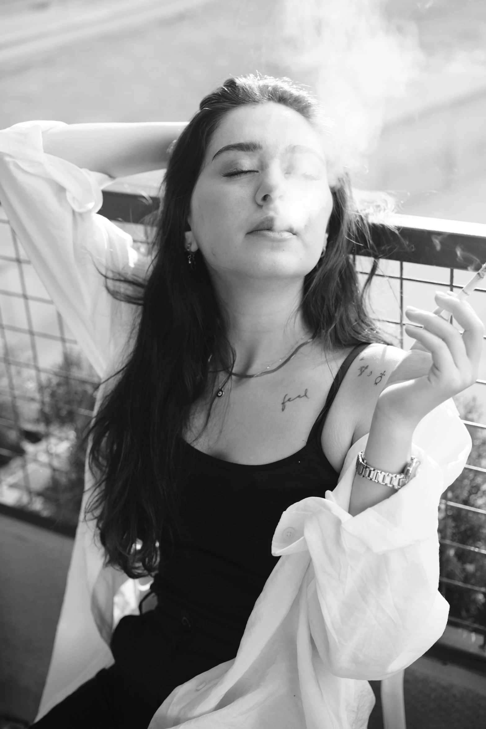black and white po of girl smoking with eyes closed