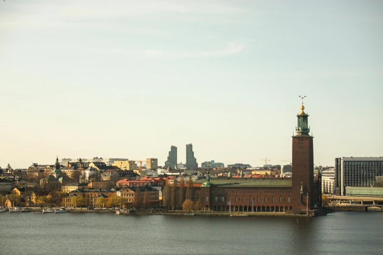 a tall tower with a clock on top near the water