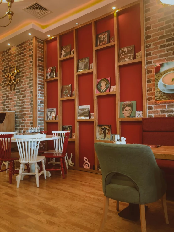 the inside of a restaurant with white chairs and a table