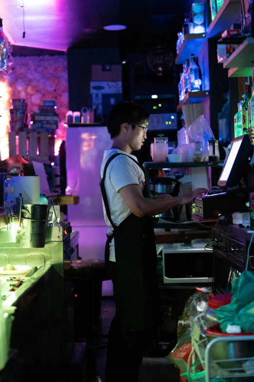 a man standing next to a bar in a room