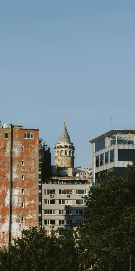 a clock on top of a building near buildings