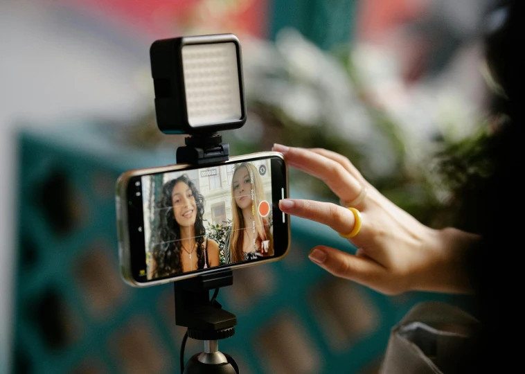 a woman is taking her own picture with her cell phone