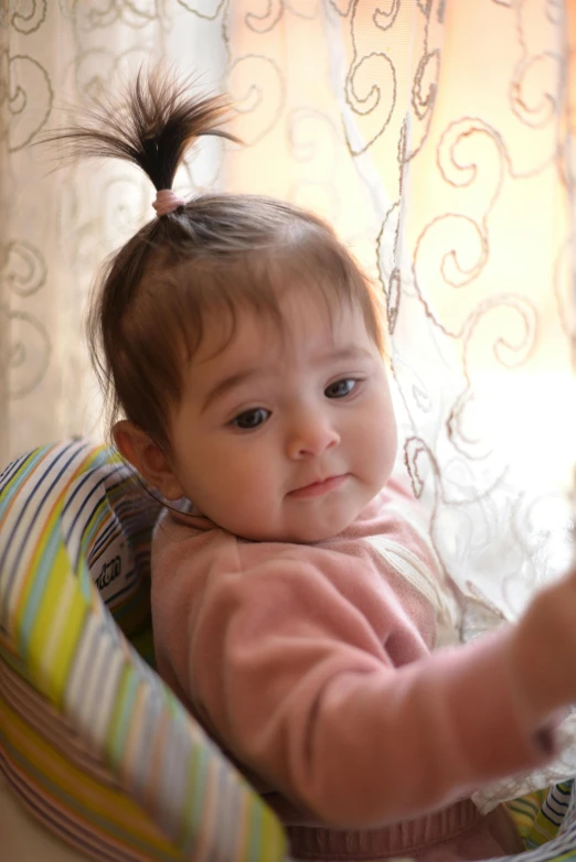 a little girl sitting in a small chair