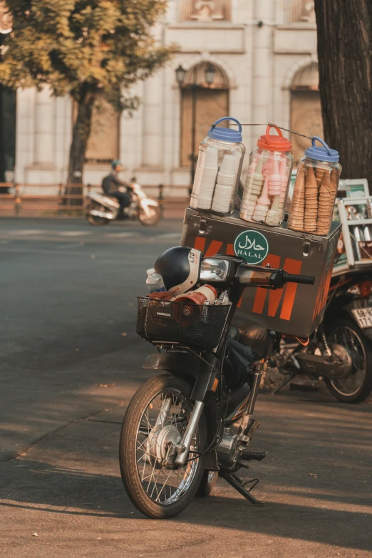 an old motorcycle has a cart with packages on it