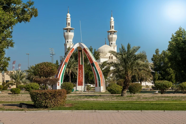 two large ornate white buildings sitting on top of a lush green park