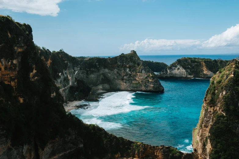 rocky coastline surrounded by blue water and turquoise sea