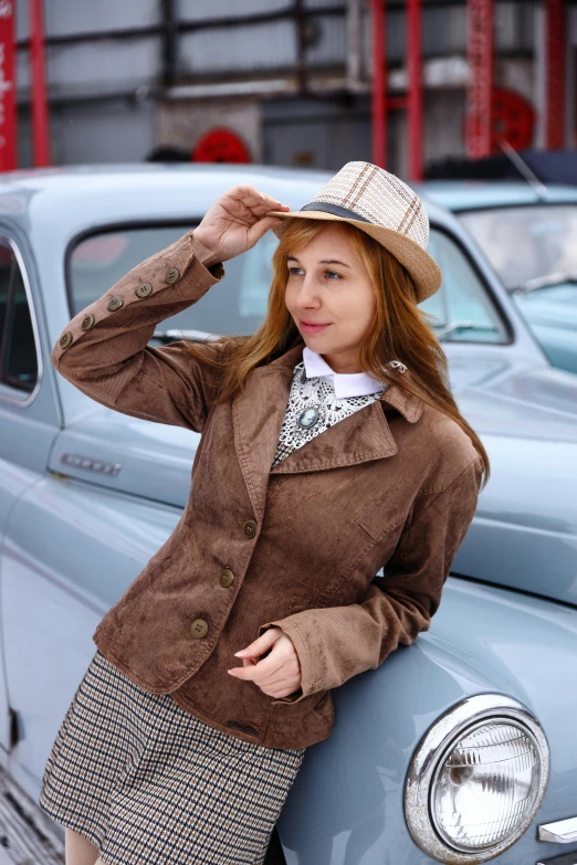 a woman is leaning against a vintage car