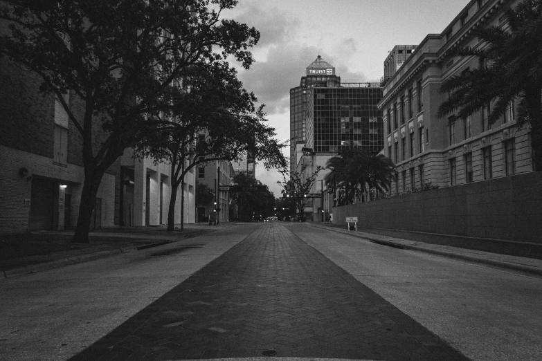 an empty street lined with several buildings and trees