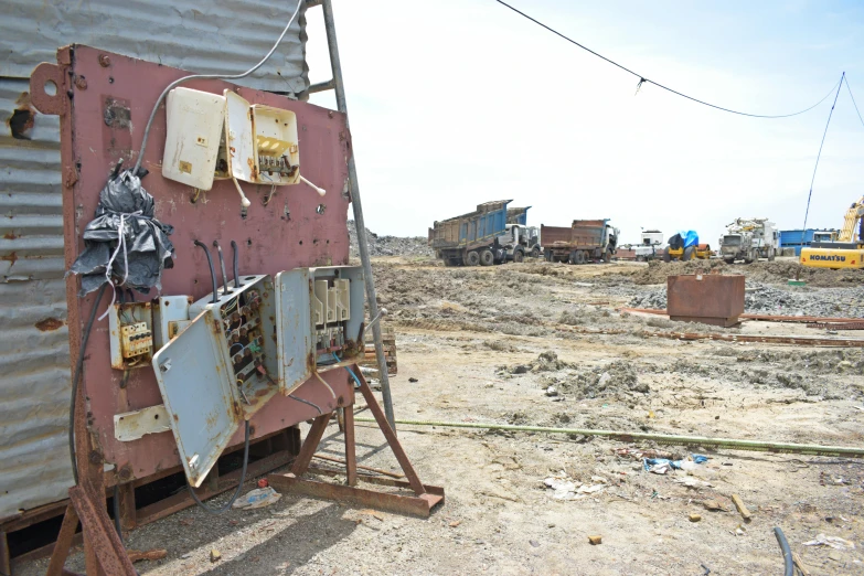 junked metal and wooden structure in an open dirt field