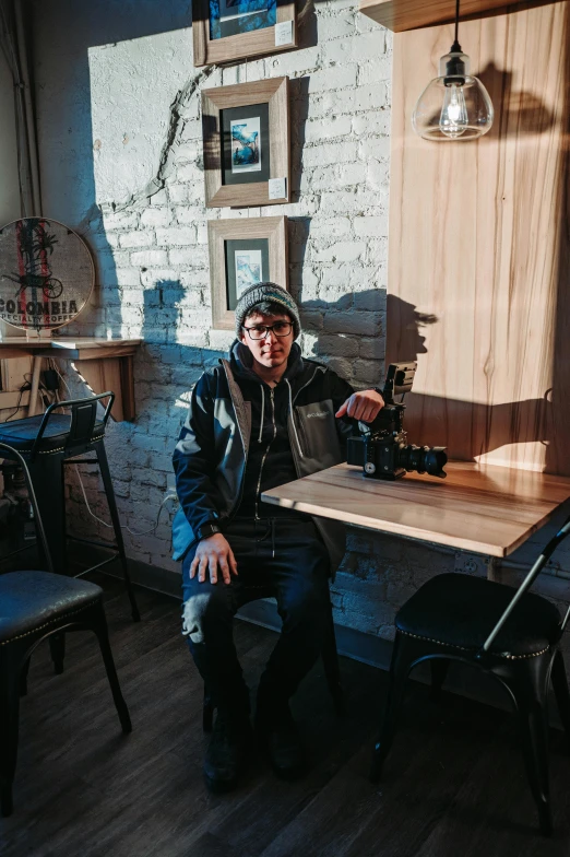 a man is sitting at the table and posing for a picture