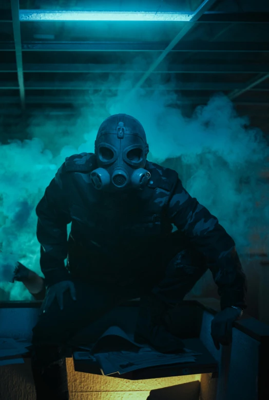 a man wearing a gas mask is surrounded by smoke