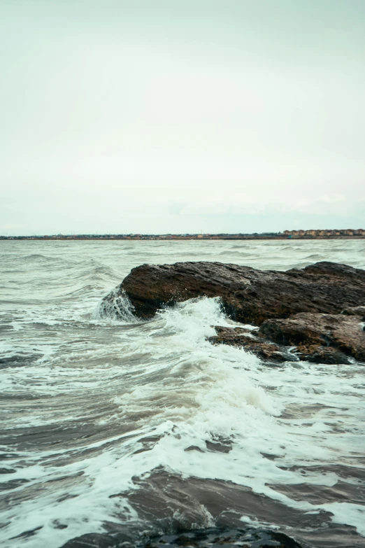 a rock formation in the middle of a body of water