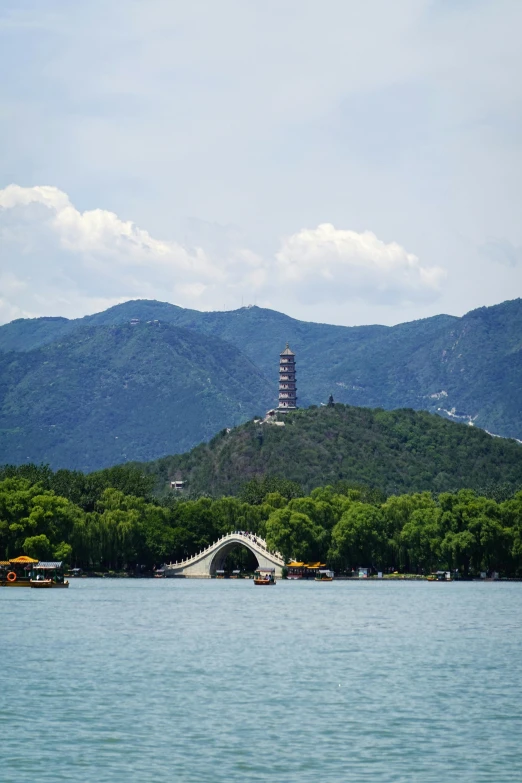 a small bridge is suspended above water by a mountain