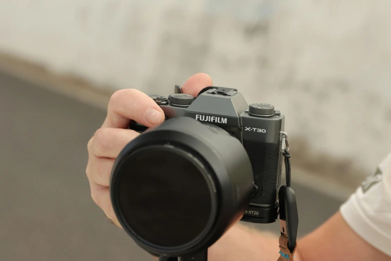 a person holding a camera near the ground