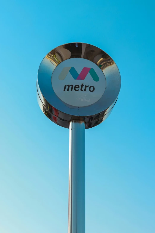 the metro sign is positioned on top of a pole